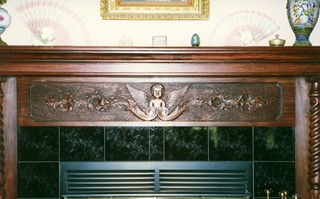 Carved cherub fireplace mantle