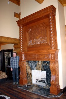 Carved fireplace surround with woodland scene