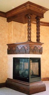 Carved three sided fireplace with rope twist columns