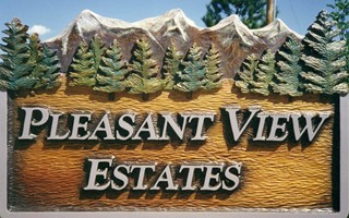 Carved sign with mountains and pines